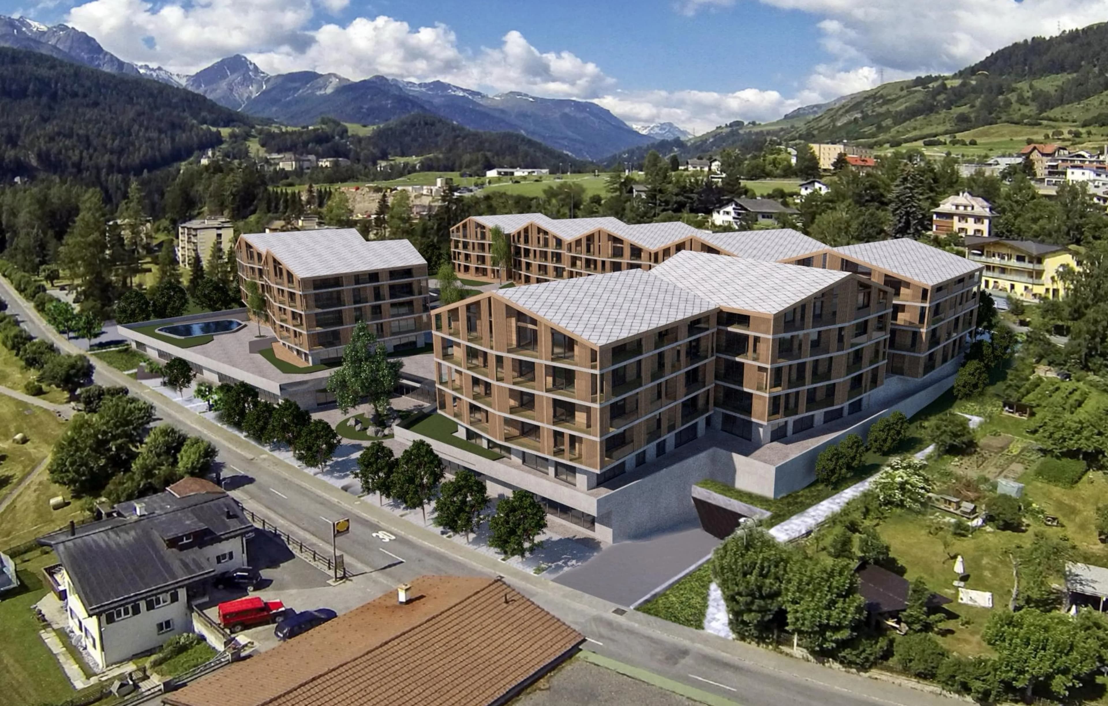 Frontansicht des Resort Scuol umgeben von Berglandschaft.